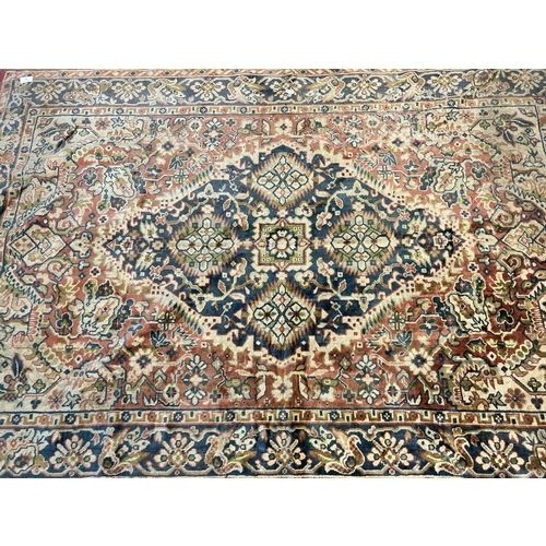 87 - A mid 20th century floral patterned rug - approx. 183cm x 122cm