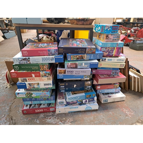 1121 - A large collection of boxed jigsaw puzzles