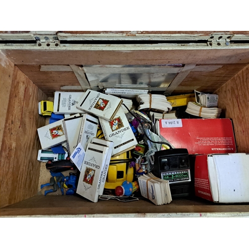 1136 - A vintage storage box containing a collection of vintage items to include boxed Hornby Railways cont... 