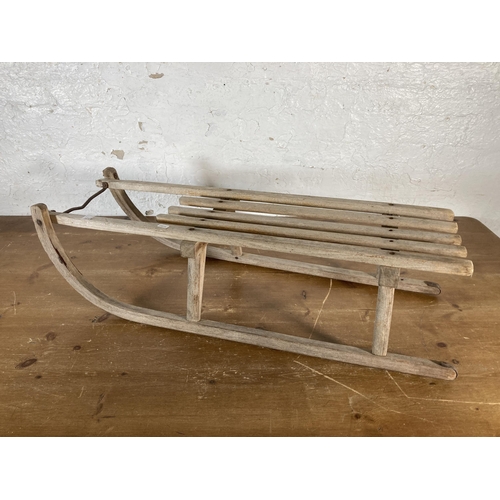 524A - A mid 20th century wooden sledge - approx. 92cm long