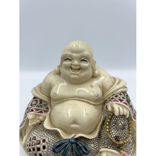 2351 - A Chinese resin buddha figurine - approx. 12cm high