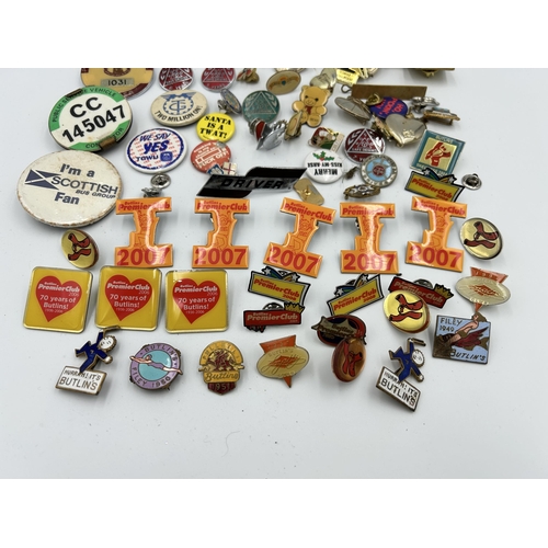 2352 - A collection of badges and buttons to include Macclesfield Town F.C., Butlins etc.