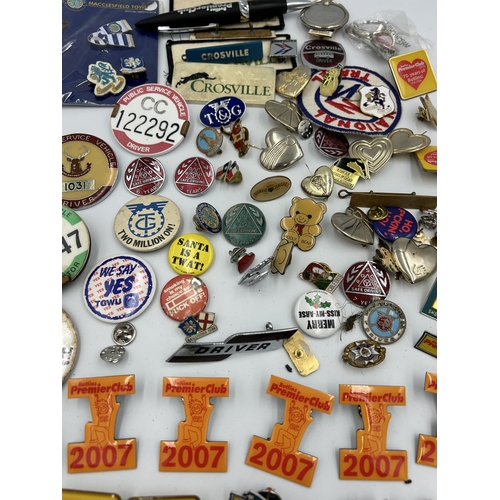 2352 - A collection of badges and buttons to include Macclesfield Town F.C., Butlins etc.