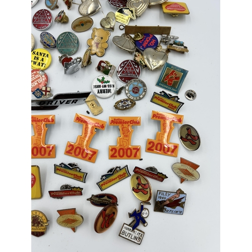 2352 - A collection of badges and buttons to include Macclesfield Town F.C., Butlins etc.