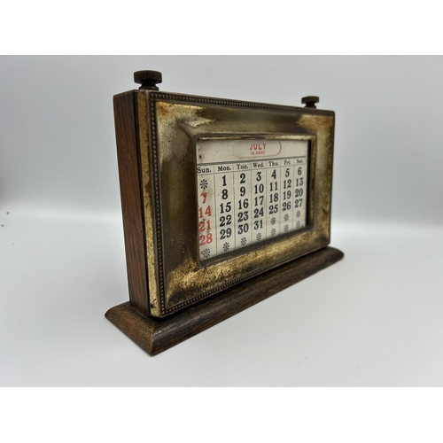 2353 - An early 20th century oak and silver plated desk calendar - approx. 14cm high x 20cm wide x 15cm dee... 