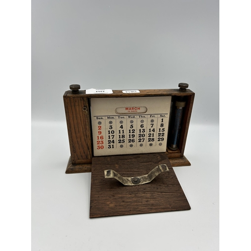 2353 - An early 20th century oak and silver plated desk calendar - approx. 14cm high x 20cm wide x 15cm dee... 