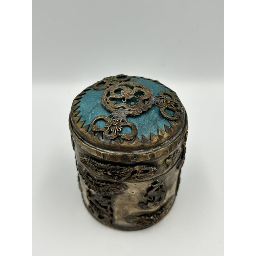 2356 - Three Oriental items, one Tibetan white metal and stone cylindrical lidded box, one Tibetan white me... 