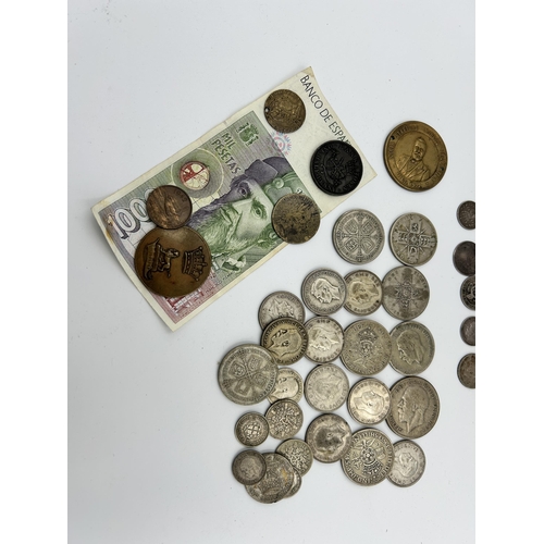 2358 - A collection of mostly British coins with silver examples to include 92.5% 1887 florin, two shilling... 