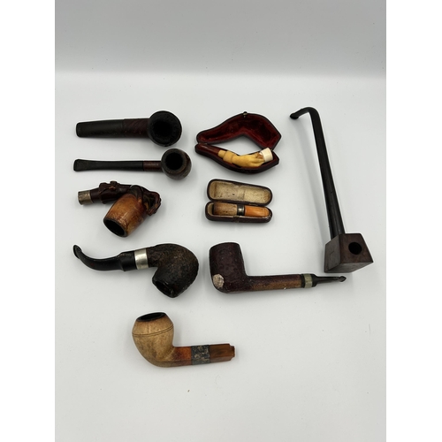 2362 - Nine pieces of tobacciana, one cased meerschaum and amber cheroot holder with hallmarked Birmingham ... 