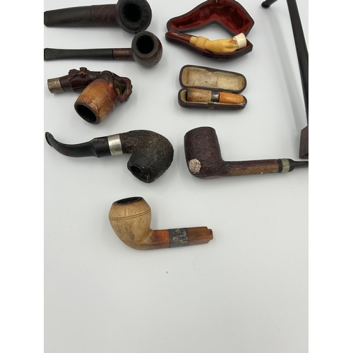 2362 - Nine pieces of tobacciana, one cased meerschaum and amber cheroot holder with hallmarked Birmingham ... 