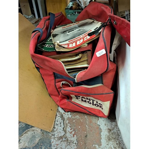 1161 - A boxed and a bag containing Triumph motorcycle jacket, a large collection of vintage motorsport rel... 