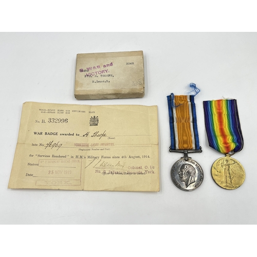 2037 - A boxed WWI British medal pair presented to 24250 Pte. H. Thorpe. R. Lanc. R.