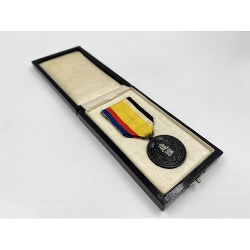 2048 - A boxed Manchukuo National Foundation Merit medal