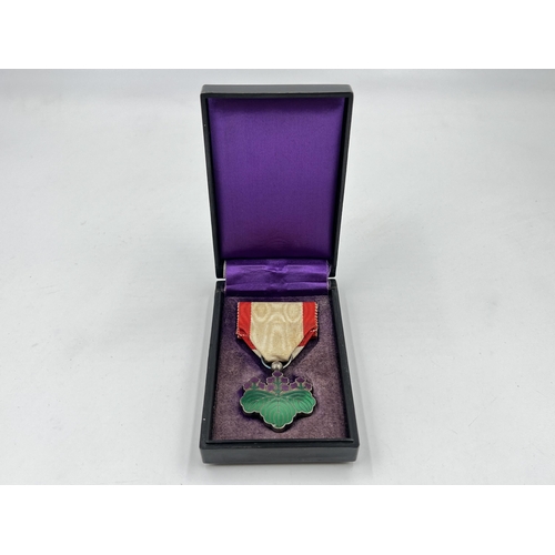 2049 - A boxed Japanese Order of The Rising Sun 7th Class medal