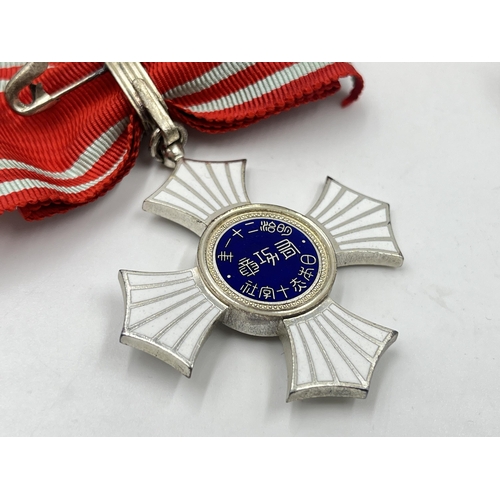 2066 - A boxed Japanese Red Cross Silver Merit medal