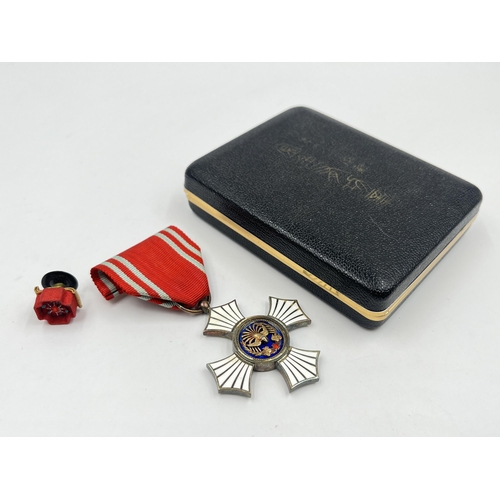 2072 - A boxed Japanese Red Cross Silver Merit medal for women