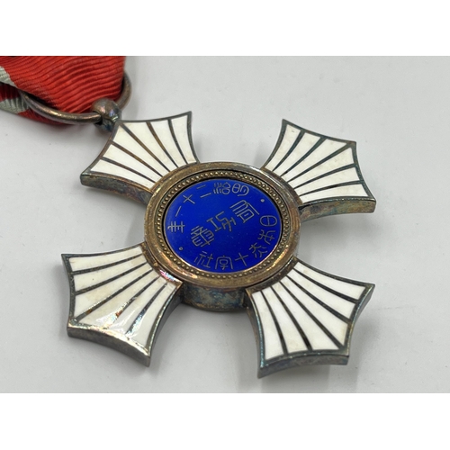 2072 - A boxed Japanese Red Cross Silver Merit medal for women