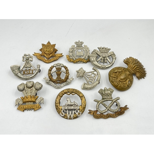 2099 - Ten military cap badges to include South Staffordshire, Worcestershire, Cornwall etc.