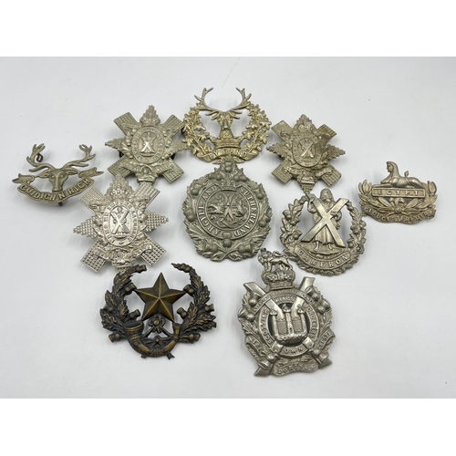 2100 - Ten military cap badges to include Gloucestershire, Queen's Own Cameron Highlanders etc.