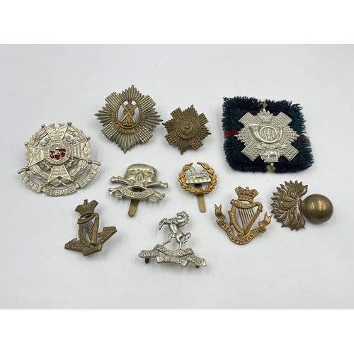 2105 - Ten military cap badges to include Egypt, The Royal Scots, The Border Regt. etc.