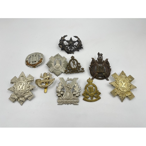 2106 - Ten military cap badges to include Royal Canadian Corps of Signals, Northamptonshire, Tyneside Scott... 