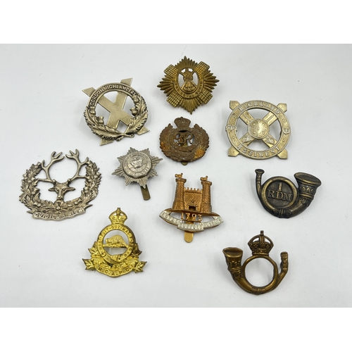 2108 - Ten military cap badges to include Gordon Highlanders, The Royal Scots etc.