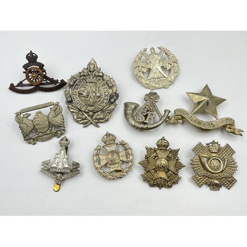 2114 - Ten military cap badges to include Argyll and Sutherland, The Robin Hoods, The Cameronians etc.