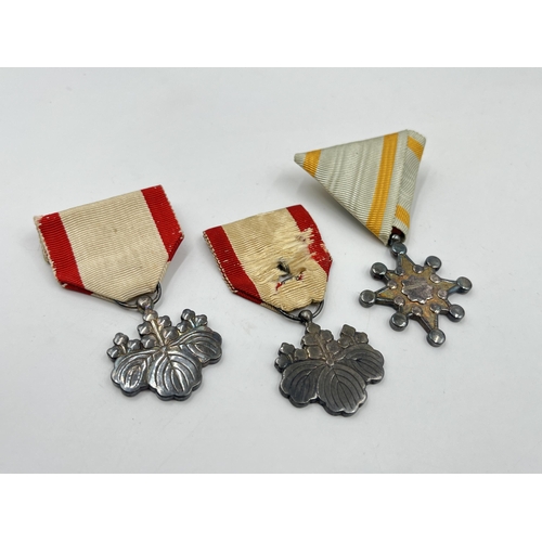 2124 - Three WWII Japanese medals, two Order of The Rising Sun 8th Class and one Order of the Sacred Treasu... 