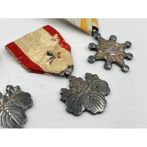 2124 - Three WWII Japanese medals, two Order of The Rising Sun 8th Class and one Order of the Sacred Treasu... 