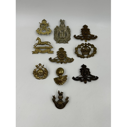 2138 - A collection of military cap badges