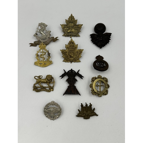 2141 - A collection of military cap badges