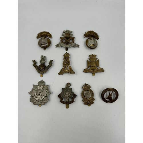 2145 - A collection of military cap badges