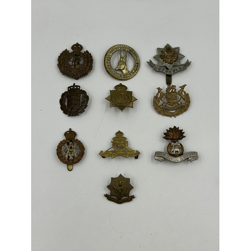 2146 - A collection of military cap badges