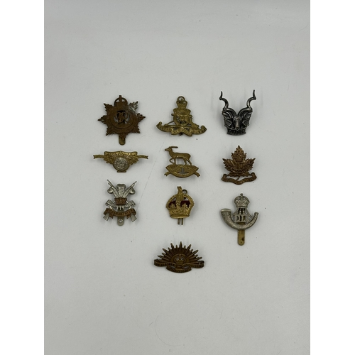 2147 - A collection of military cap badges