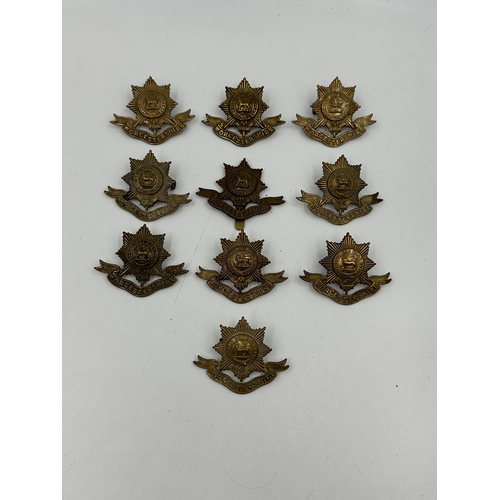 2148 - A collection of military cap badges