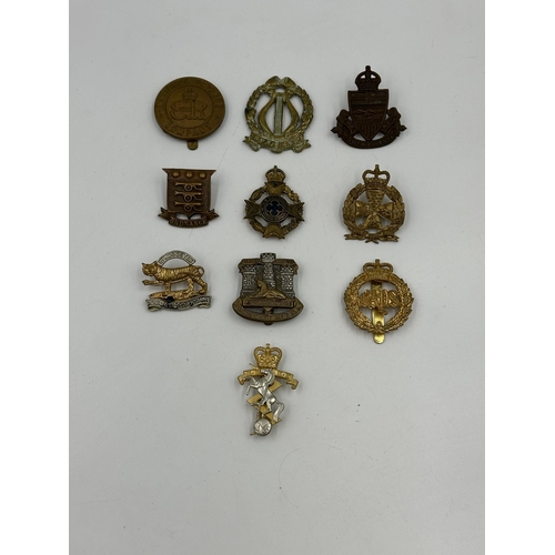 2149 - A collection of military cap badges