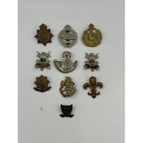 2150 - A collection of military cap badges