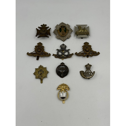 2151 - A collection of military cap badges