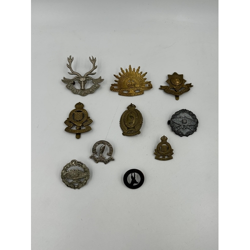 2153 - A collection of military cap badges