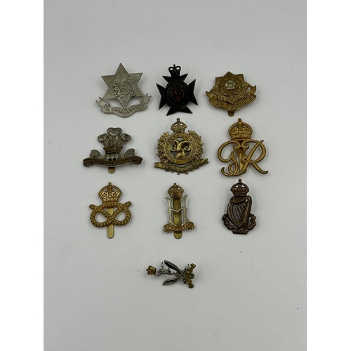 2155 - A collection of military cap badges