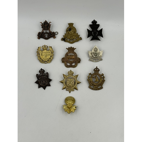 2157 - A collection of military cap badges