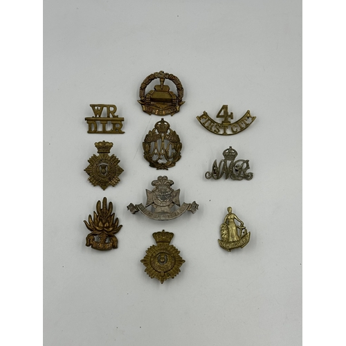 2158 - A collection of military cap badges