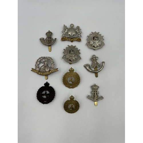 2159 - A collection of military cap badges