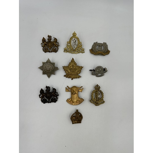 2166 - A collection of military cap badges