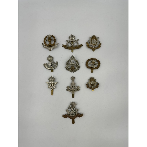 2168 - A collection of military cap badges