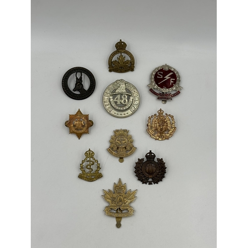 2169 - A collection of military cap badges