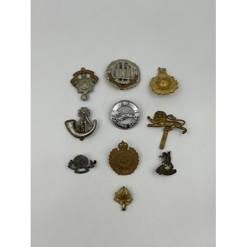 2170 - A collection of military cap badges