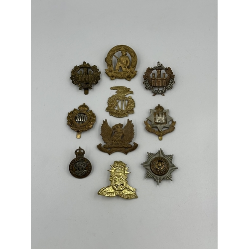 2171 - A collection of military cap badges