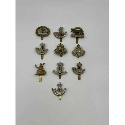 2175 - A collection of military cap badges