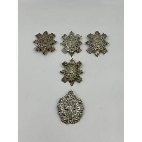 2176 - A collection of military cap badges